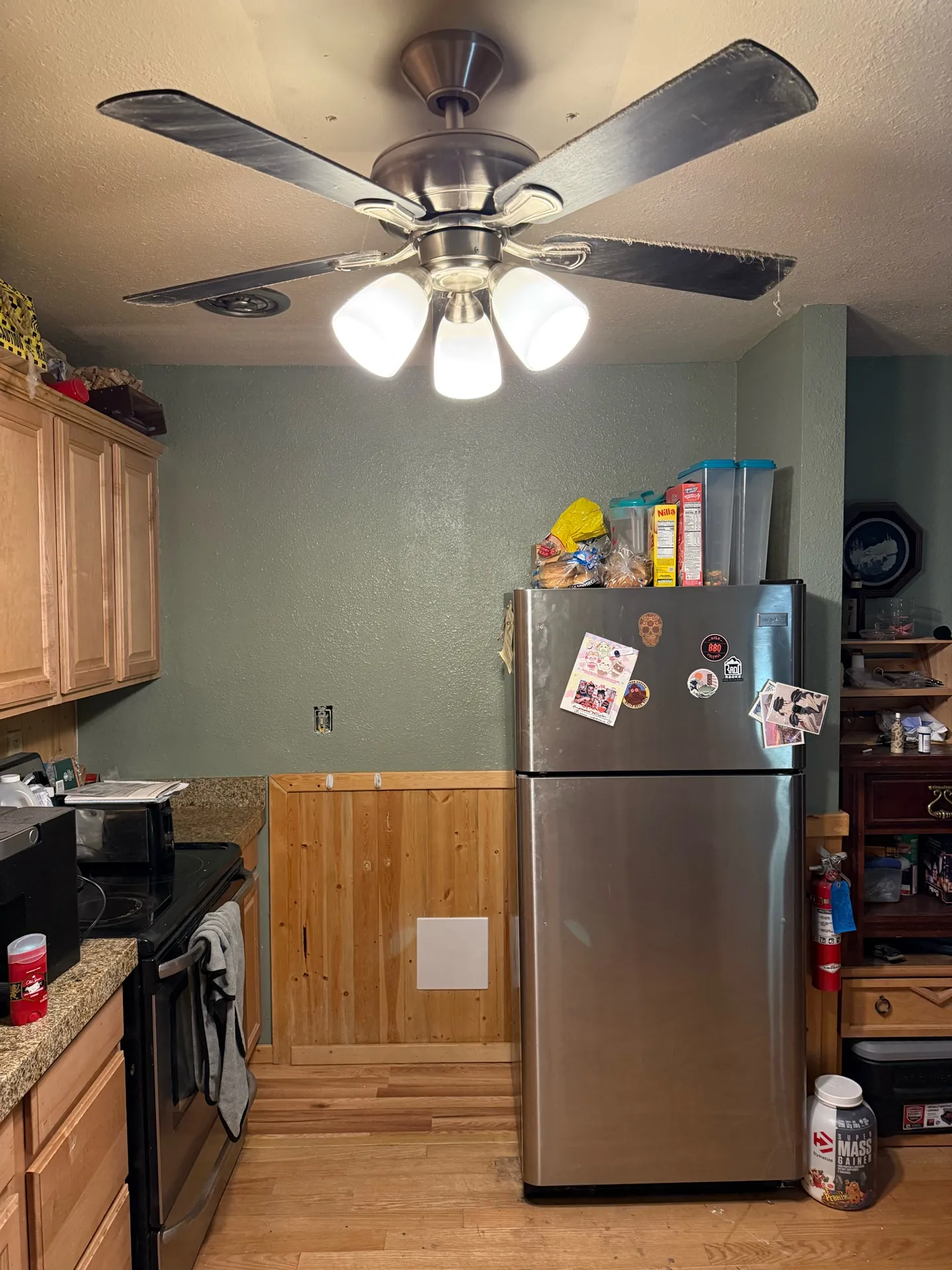 Brian Head kitchen repair — full kitchen view showing completed wall repair with ceiling fan, stove, and cabinetry in context
