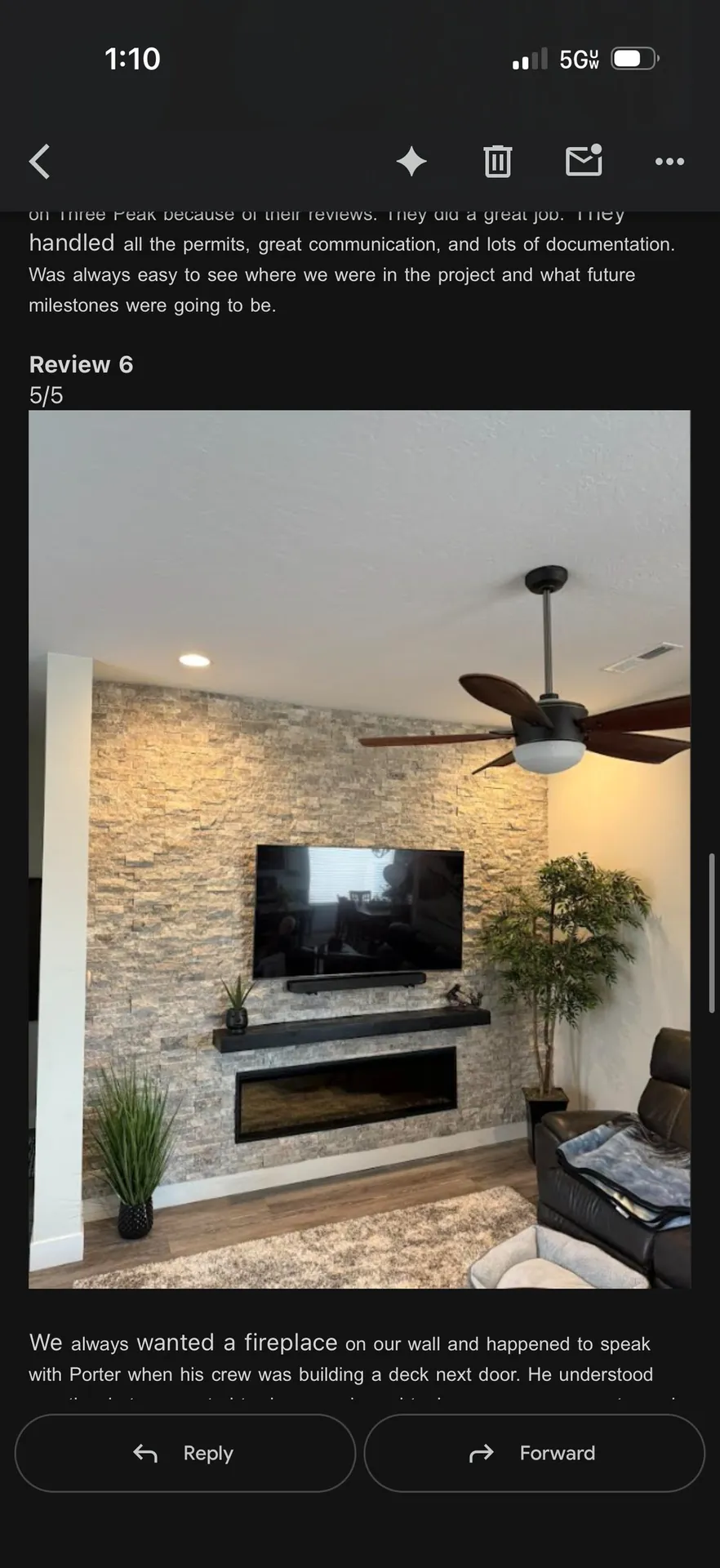 Stacked stone fireplace wall with TV mount and linear electric fireplace insert