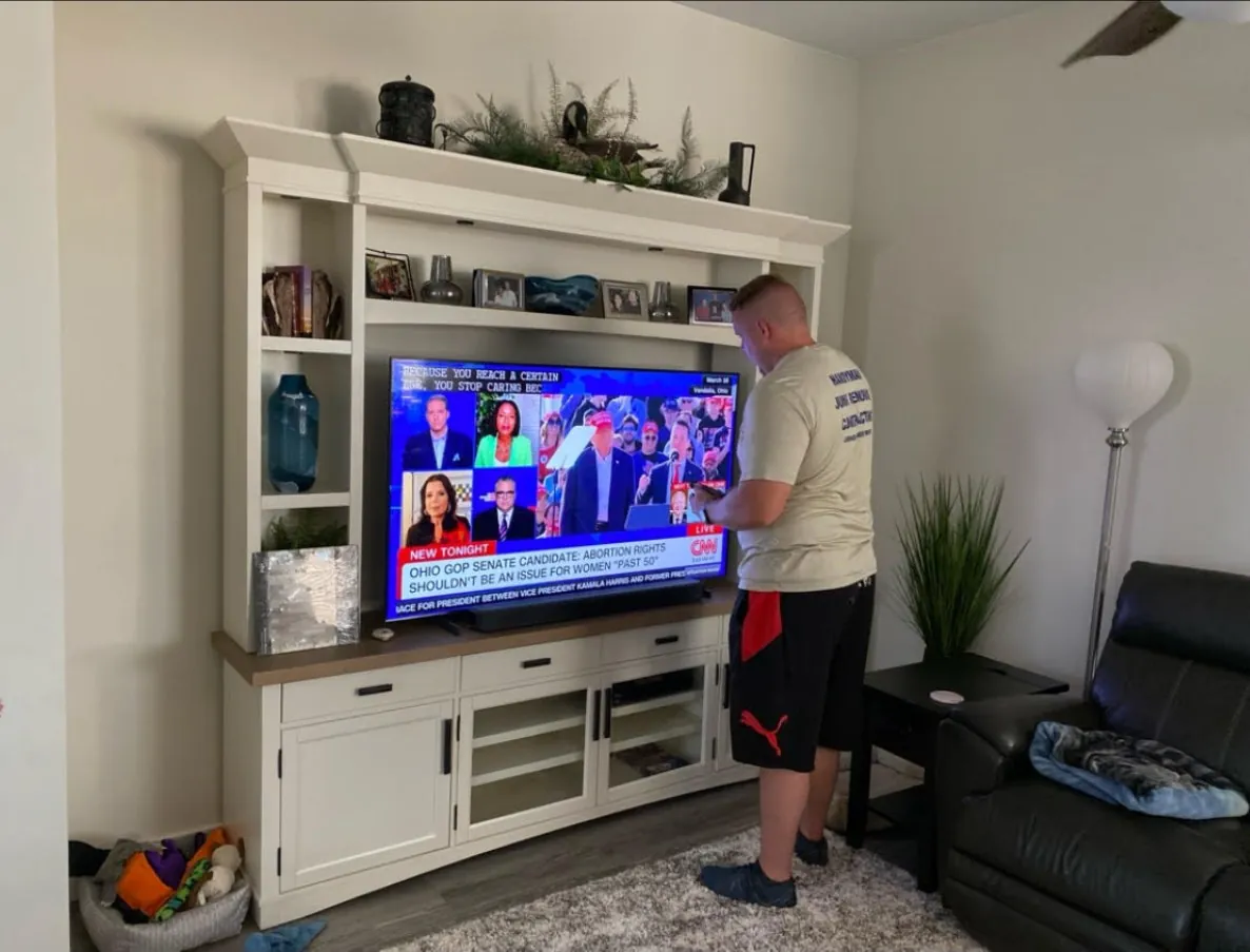 Before: living room with white entertainment center — before fireplace wall build