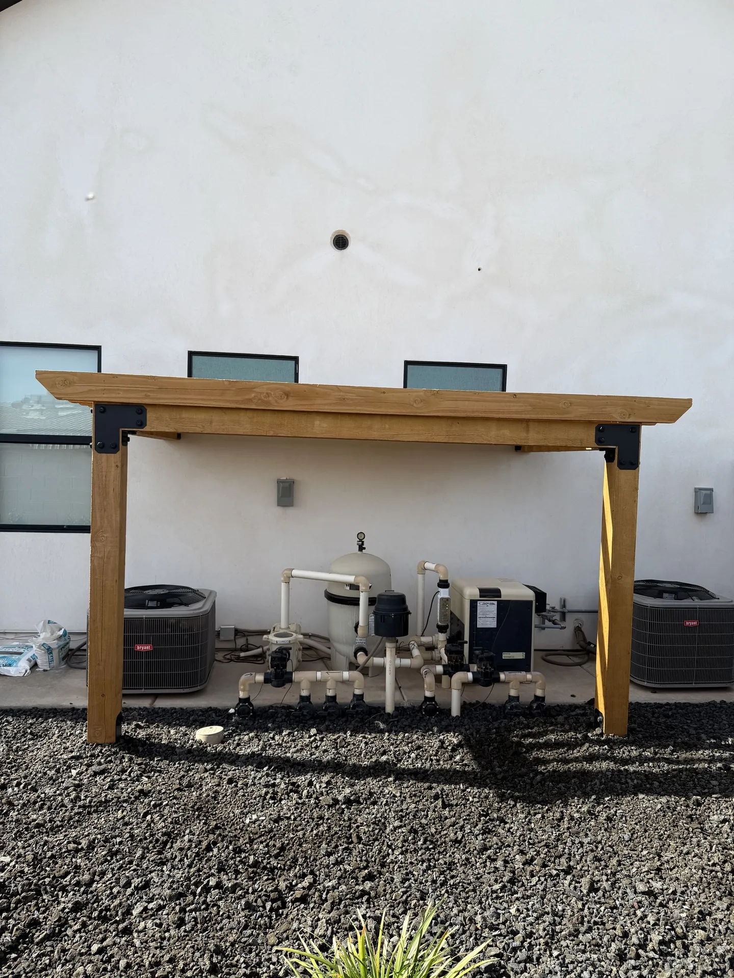 Viking Solutions cedar pergola over pool equipment — front view showing clean beam and post framing with black steel hardware