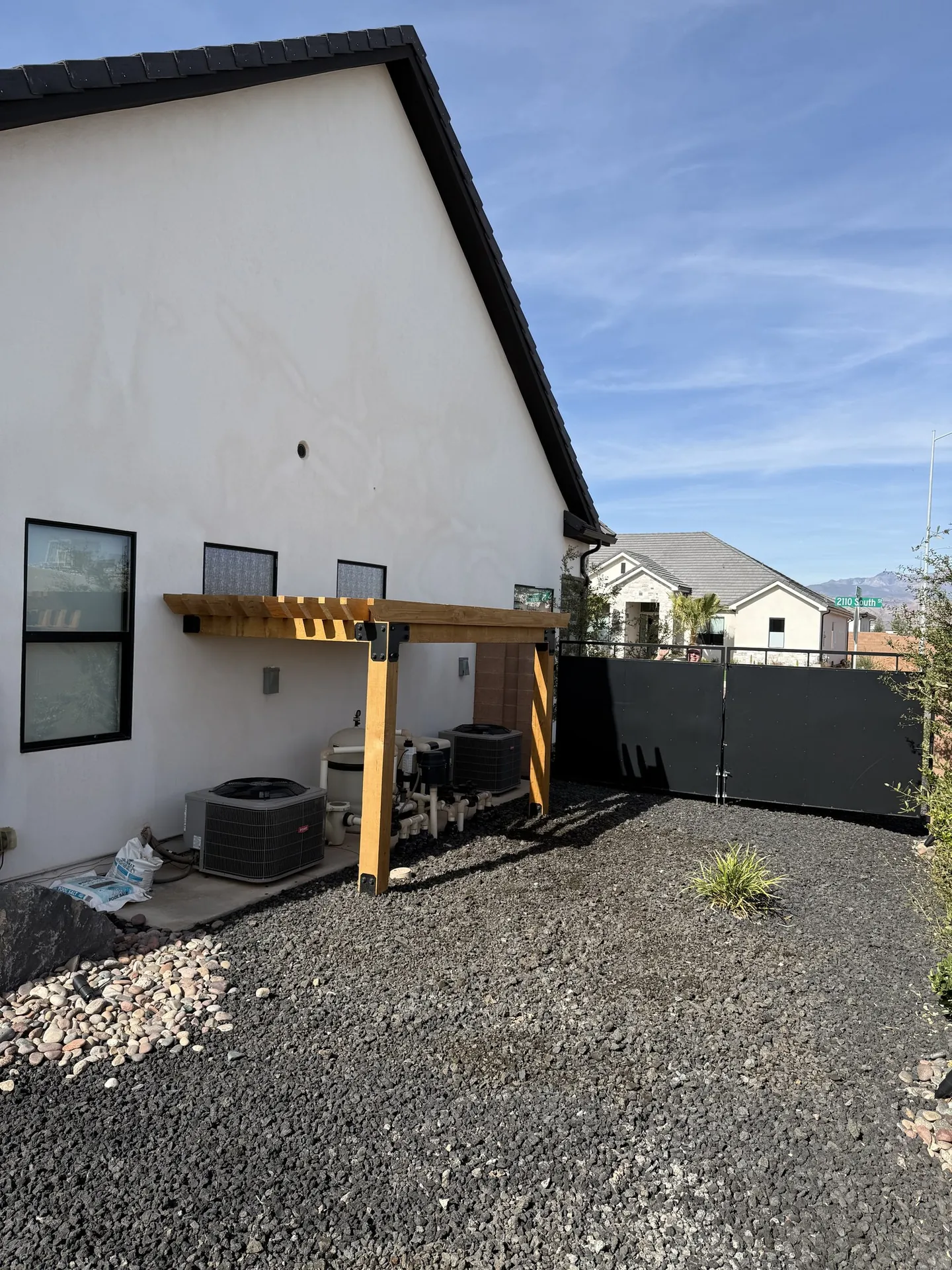 Full house side view showing the pergola in context with the home exterior