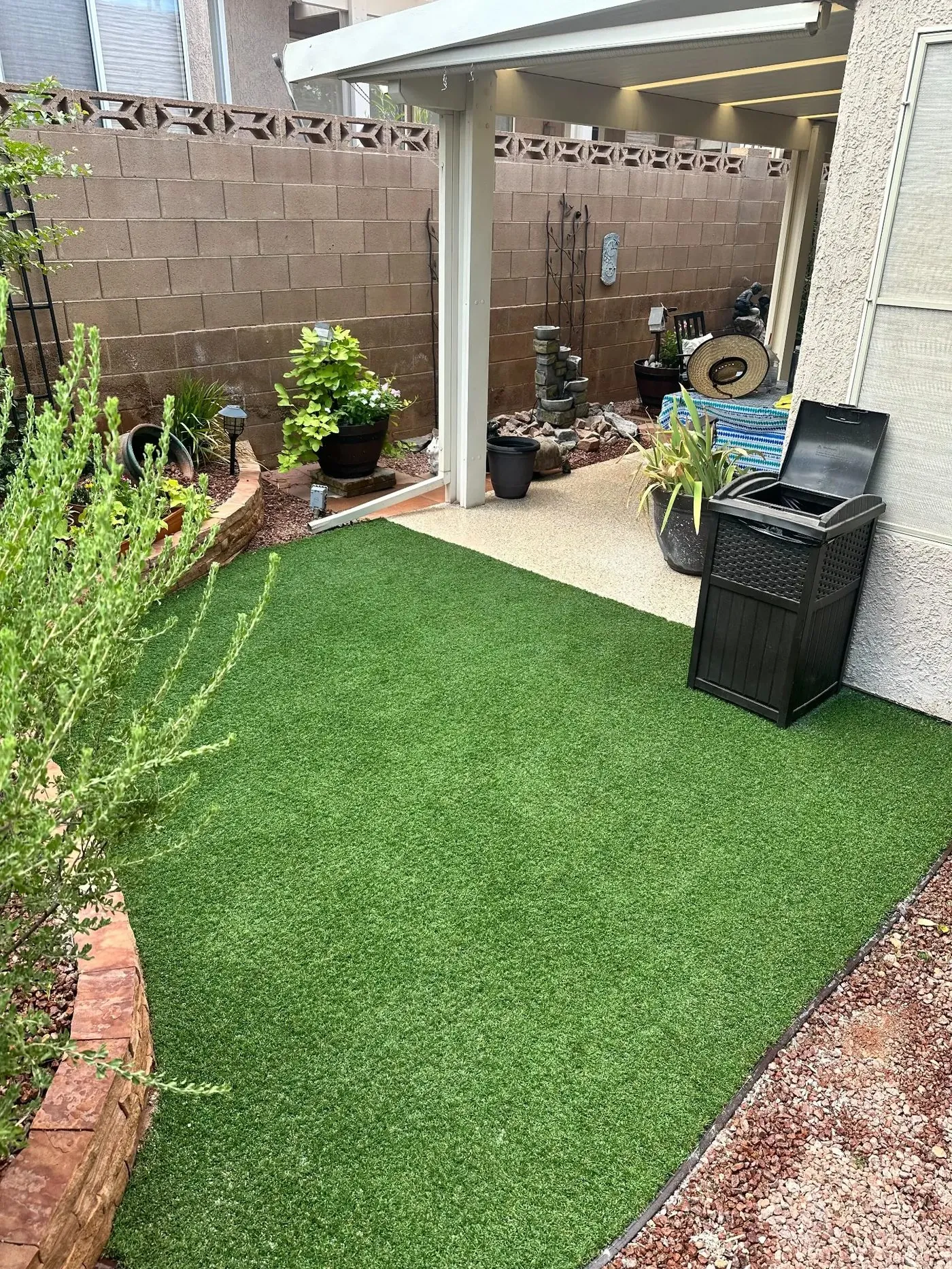 Finished artificial turf in St. George — view from covered patio showing full green turf area and desert landscaping